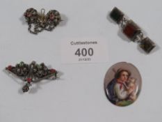 A VICTORIAN SCOTTISH HARDSTONE BROOCH AND THREE OTHERS