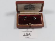 A PAIR OF 9CT WHITE GOLD ONYX AND DIAMOND STUDS BY GARRARD