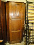 AN OAK LINENFOLD WARDROBE