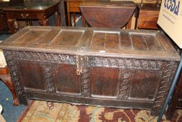 AN ANTIQUE OAK PANELLED COFFER W-144 CM