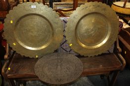 TWO EASTERN BRASS CHARGERS AND A CAST PLAQUE