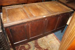 AN ANTIQUE OAK PANELLED COFFER W-134 CM