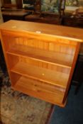 A MODERN HONEY PINE OPEN BOOKCASE