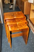 A NEST OF THREE ART DECO WALNUT TABLES W-52 CM LARGEST