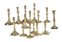 A COLLECTION OF FIFTEEN VARIOUS BRASS CANDLESTICKS