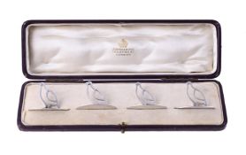 A SET OF FOUR SILVER BIRD MENU HOLDERS