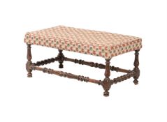 A WALNUT AND UPHOLSTERED STOOL
