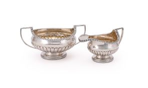 A GEORGE III SILVER SUGAR BOWL AND CREAM JUG