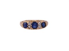 A LATE VICTORIAN SEVEN STONE DIAMOND AND SAPPHIRE RING, CIRCA 1900