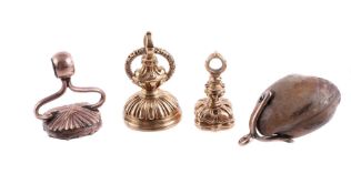 THREE 19TH CENTURY FOB SEALS AND A FOSSILISED SHELL FOB/PENDANT