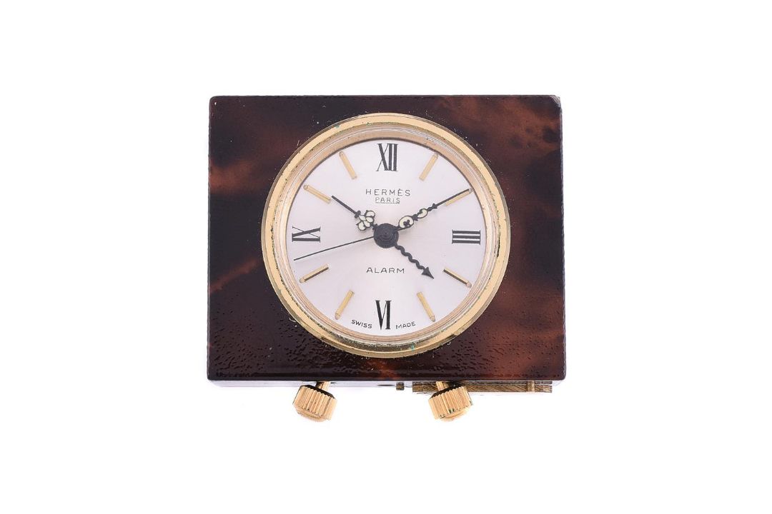 HERMES, A BRASS AND BROWN LACQUERED TRAVEL ALARM CLOCK - Image 1 of 2