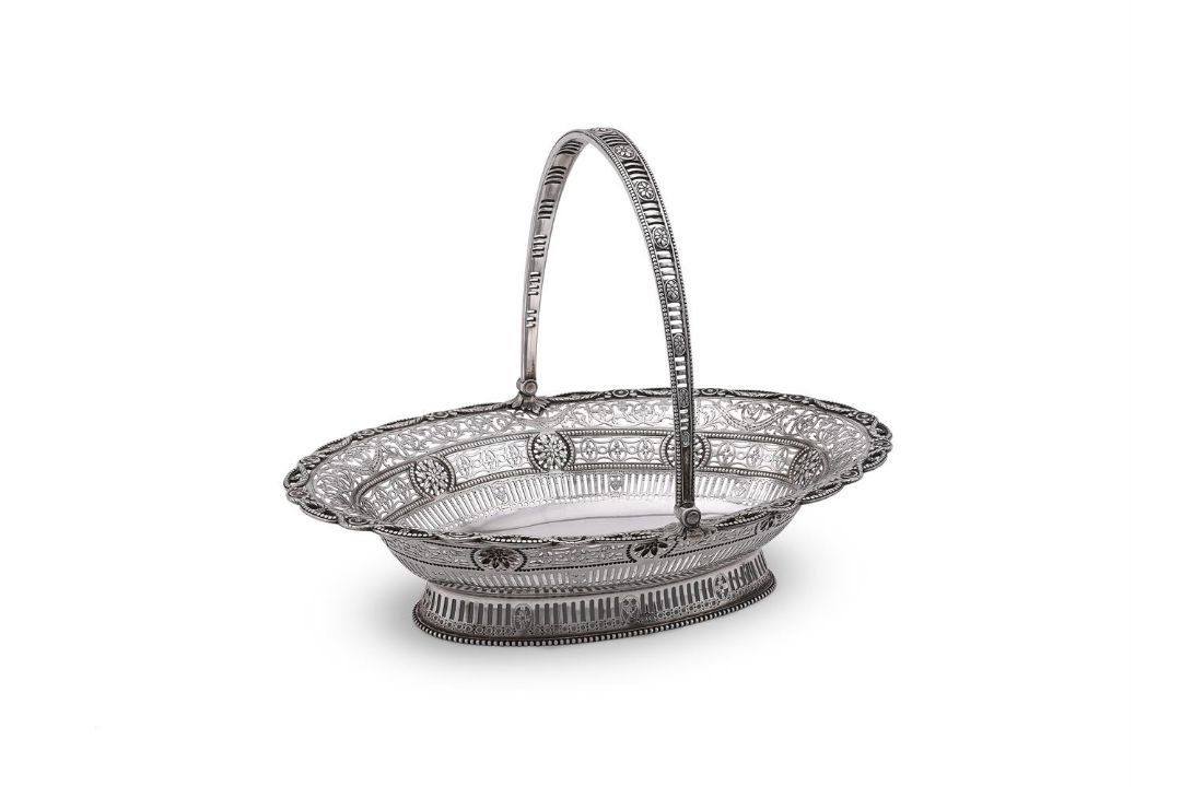 A GEORGE III SILVER OVAL SWING HANDLED BASKET - Image 1 of 3