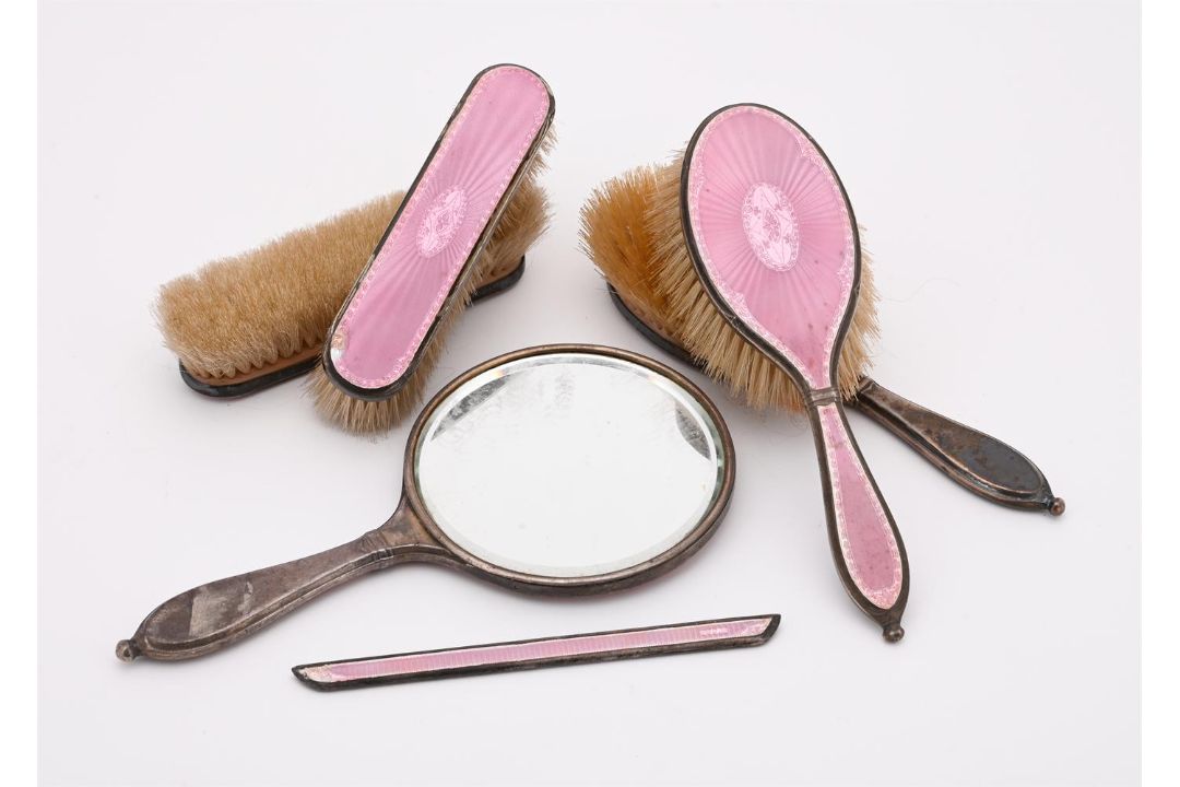 A SILVER MOUNTED AND PINK ENAMEL SIX PIECE DRESSING TABLE SET