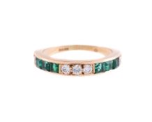 A DIAMOND AND EMERALD HALF ETERNITY RING, LONDON 1981
