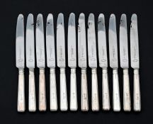 A SET OF TWELVE SILVER HANDLED TABLE KNIVES