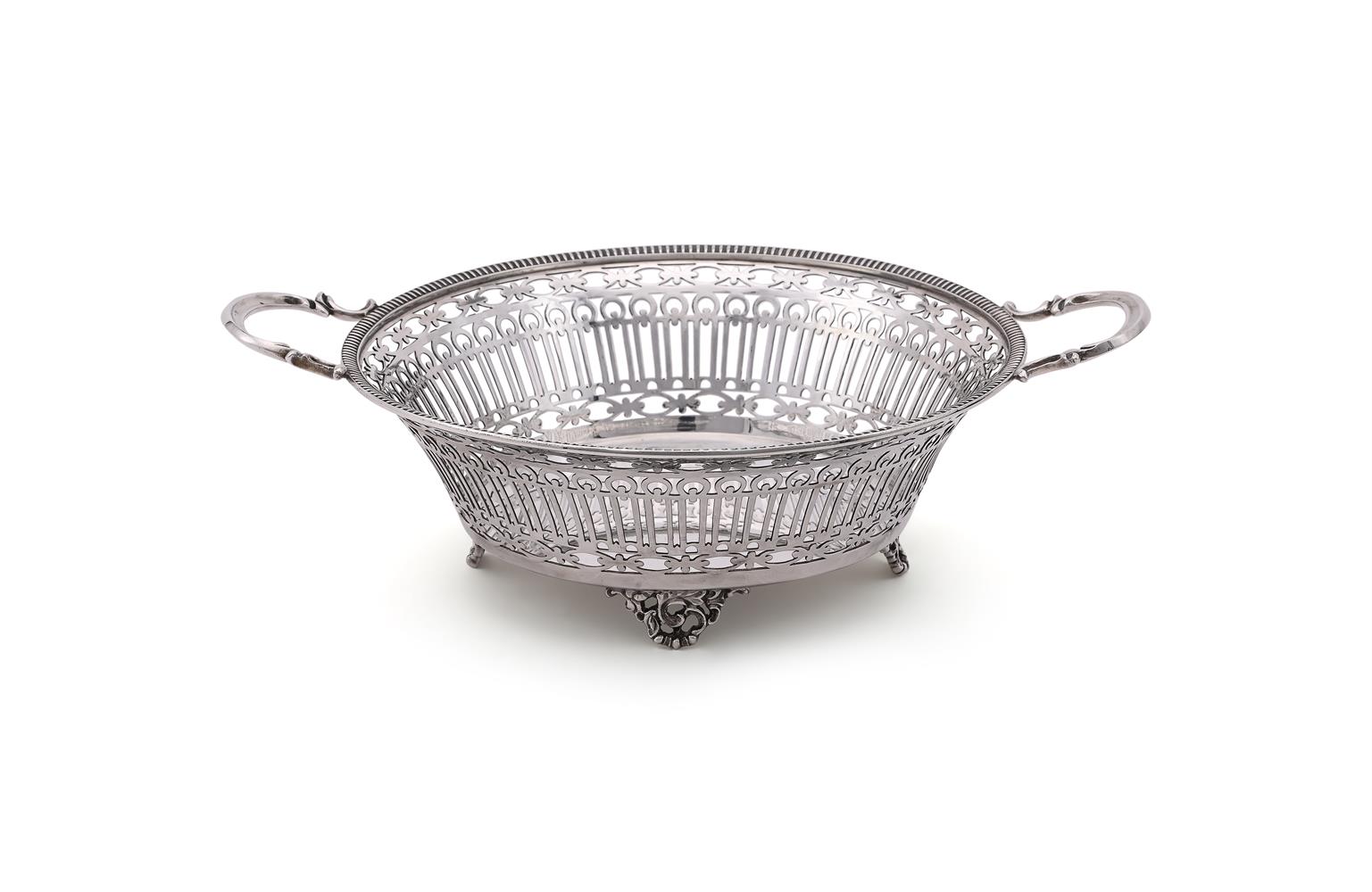 A SILVER CIRCULAR TWIN HANDLED BASKET