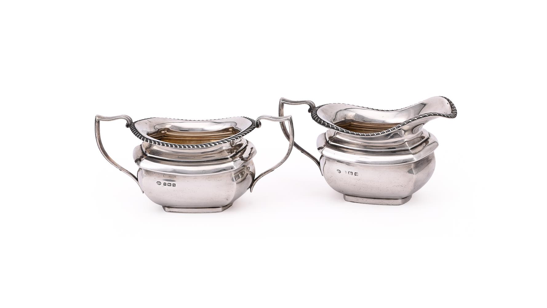 A SILVER OBLONG BALUSTER CREAM JUG AND TWIN HANDLED SUGAR BOWL