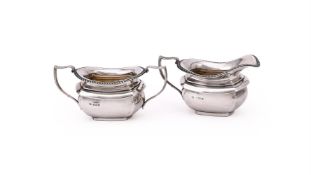A SILVER OBLONG BALUSTER CREAM JUG AND TWIN HANDLED SUGAR BOWL