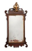 A MAHOGANY AND PARCEL GILT WALL MIRROR