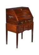 A GEORGE III MAHOGANY BUREAU ON STAND