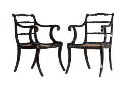 A PAIR OF REGENCY EBONISED AND BRASS INLAID ARMCHAIRS