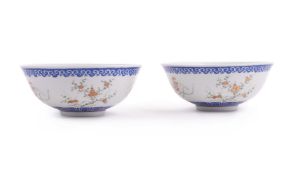 A pair of Chinese Famille Rose and blue enamelled bowls