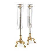 A RARE PAIR OF FRENCH SILVERED AND GILDED BRONZE 'POMPEIIAN' TRIPOD TORCHERES/STANDS BY BARBEDIENNE