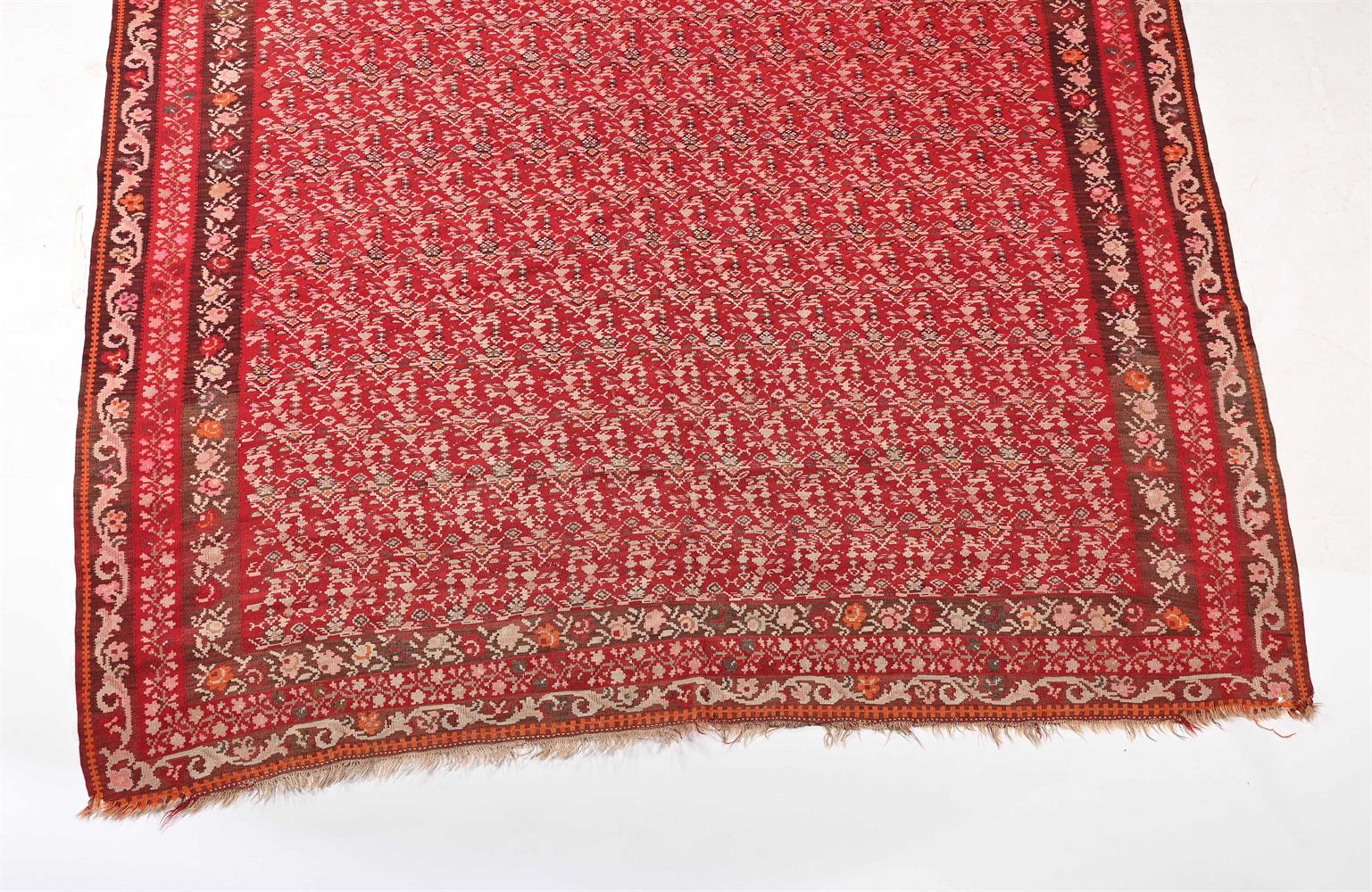 A SENNEH RED GROUND KELIM CARPET - Image 2 of 2
