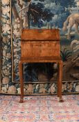 A GEORGE I WALNUT BUREAU ON STAND, CIRCA 1720