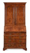 A GEORGE II FIGURED WALNUT AND FEATHER-BANDED BUREAU BOOKCASE, IN THE MANNER OF COXED & WOSTER
