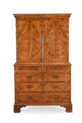 A GEORGE II FIGURED WALNUT CABINET ON CHEST, CIRCA 1720