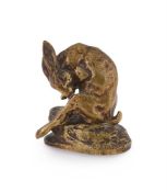 CLOVIS-EDMOND MASSON (FRENCH, 1838-1913), A GILT BRONZE MODEL OF A HARE GROOMING ITS BACK LEG