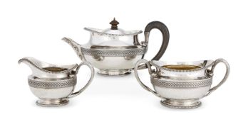 A GEORGE III SILVER THREE PIECE CIRCULAR TEA SET