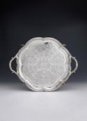 AN EARLY VICTORIAN SILVER TWIN HANDLED SHAPED CIRCULAR TRAY