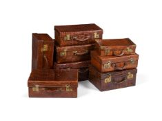 Y A COLLECTION OF EIGHT 'CROCODILE' LEATHER CASES