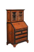 A MAHOGANY AND EBONISED BUREAU BOOKCASE OF CAMPAIGN TYPE