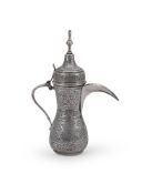 AN EGYPTIAN SILVER COLOURED BALUSTER COFFEE POT