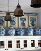 A SET OF THREE ANTIQUED BRASS 'GOTHIC HELMET' PENDANT LIGHTS BY ROBERT KIME LTD