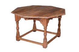 A FRENCH GOTHIC REVIVAL CARVED CHESTNUT AND OAK EXTENDING DINING TABLE