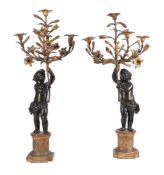 A PAIR OF EBONISED AND GILT FIGURAL CANDELABRA