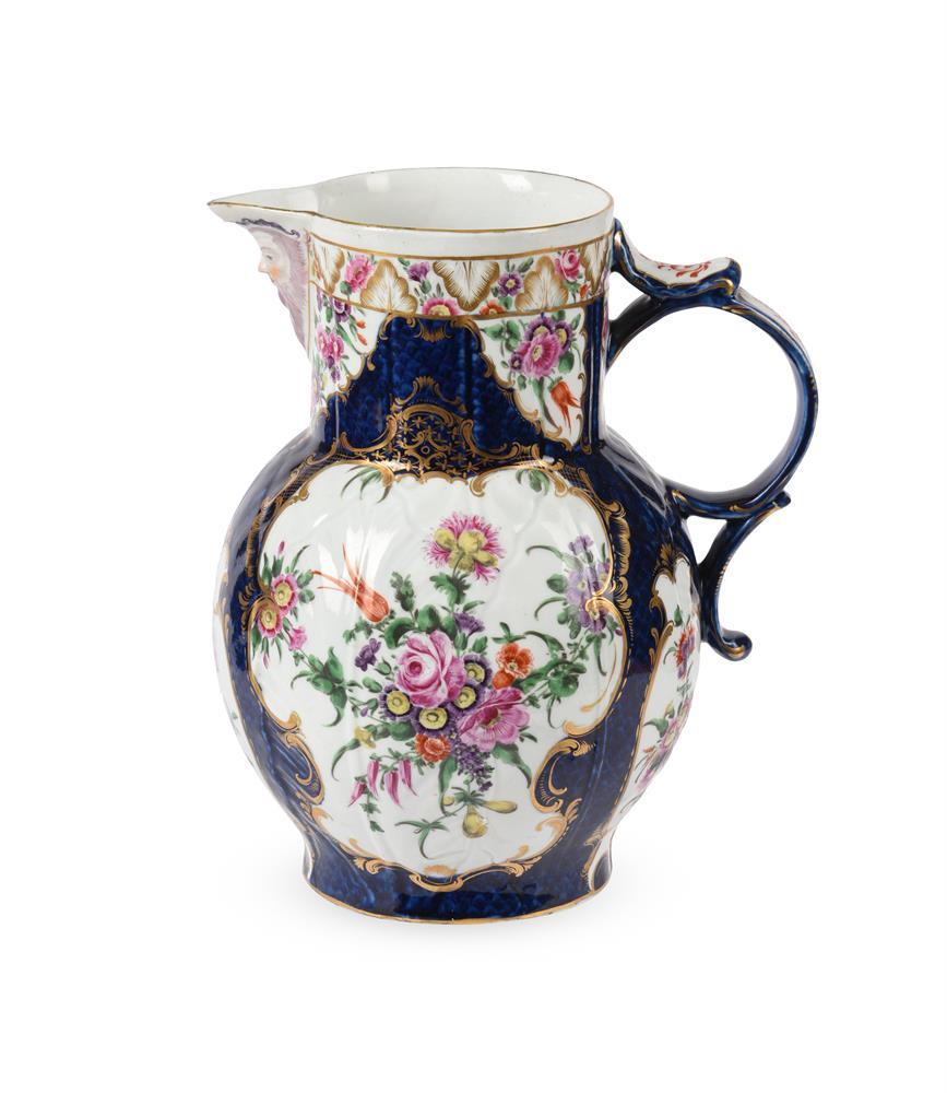 A WORCESTER POLYCHROME PORCELAIN BLUE-SCALE GROUND CABBAGE-LEAF MOULDED MASK JUG