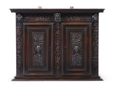 A FRENCH CARVED WALNUT CABINET, 16TH OR 17TH CENTURY