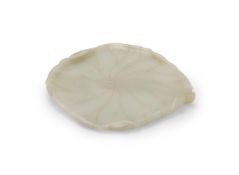 A Chinese celadon jade 'Louts leaf' washer