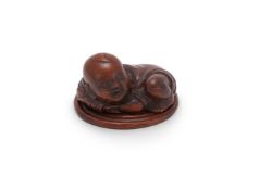A Chinese bamboo incense box and cover in the form of a boy