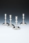 A MATCHED SET OF FOUR QUEEN ANNE AND GEORGE I SILVER OCTAGONAL CANDLESTICKS