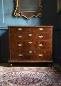 A QUEEN ANNE FIGURED WALNUT AND FEATHER-BANDED CHEST OF DRAWERS, CIRCA 1710
