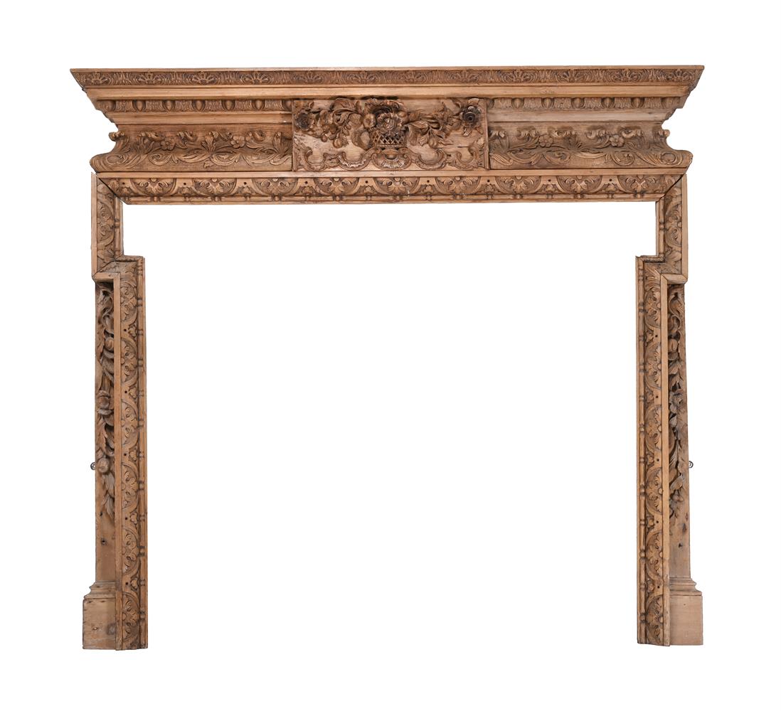 A GEORGE II CARVED PINE FIRE SURROUND, CIRCA 1740