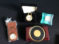 A MIXED SET OF NEW DESIGNER CLOCKS AND A SET OF COASTERS IN A STAND