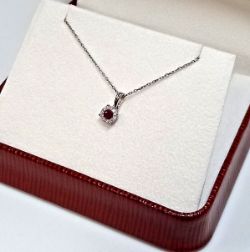 0.25CT RUBY & DIAMOND PENDANT/18CT WHITE GOLD IN GIFT BOX WITH VALUATION CERTIFICATE OF £895