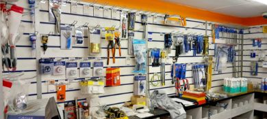 Large quantity of various plumbing tools, accessories, adhesives etc. to shelves of trade counter